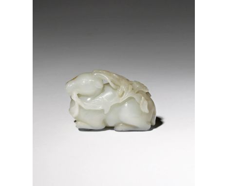 A CHINESE PALE CELADON JADE CARVING OF A DEER QIANLONG 1736-95 The stag depicted in a recumbent pose with his legs tucked und