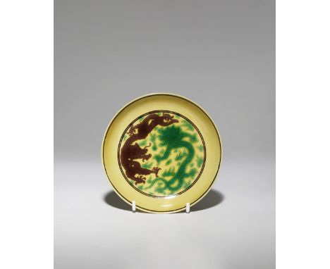 A CHINESE IMPERIAL YELLOW-GROUND 'DRAGON' SAUCER DISH SIX CHARACTER KANGXI MARK AND OF THE PERIOD 1662-1722 Finely incised to