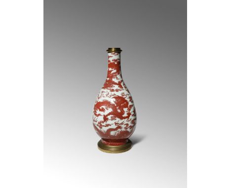 A LARGE CHINESE COPPER-RED 'FIVE DRAGON' VASE 18TH CENTURY The pear-shaped body with a tall tapering neck, decorated with sca