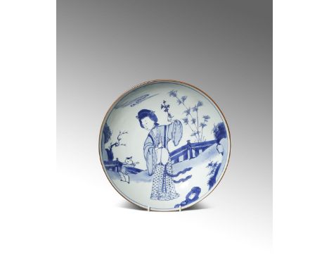 A RARE LARGE CHINESE BLUE AND WHITE DISH SIX CHARACTER KANGXI MARK AND EARLY IN THE PERIOD 1662-1722 Painted with a lady stan