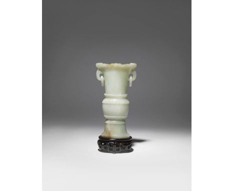 A CHINESE CELADON JADE ARCHAISTIC VASE 18TH/19TH CENTURY Of flattened form, the rim carved in relief with two stylised phoeni