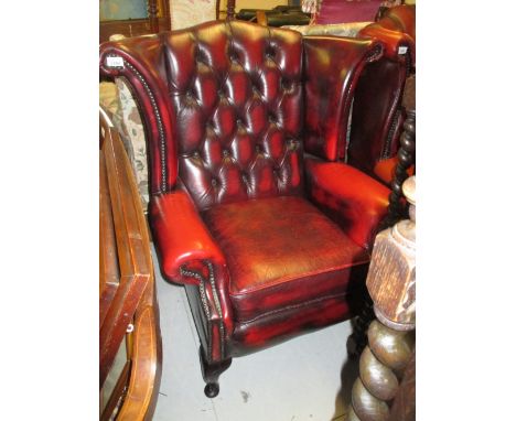 Reproduction red buttoned leather upholstered wing back armchair on cabriole front supports together with a stick back kitche
