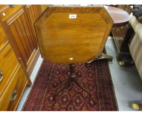 Regency rosewood burr walnut banded and brass line inlaid octagonal pedestal table with a slender turned column support and t