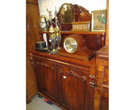 Victorian mahogany chiffonier with a carved shelf back above two frieze drawers and two cupboard doors on turned supports