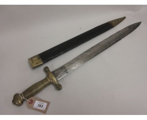 19th Century Continental short sword with shaped blade, brass grip and integral hilt in a brass mounted leather scabbard