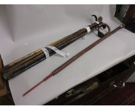 Oriental carved bamboo walking stick with concealed fishing pole, signed together with a quantity of other walking sticks