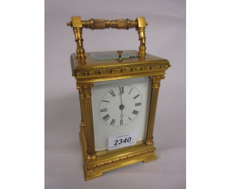 Late 19th or early 20th Century gilt brass carriage clock, the case with fluted Corinthian corner pilasters, the enamel dial 