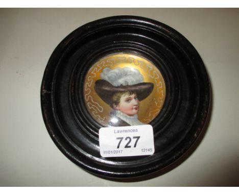 Small Continental porcelain concave plaque painted with a portrait of a lady wearing a feathered hat in a circular ebonised f