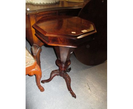 Victorian figured walnut octagonal trumpet form work table with carved tripod base