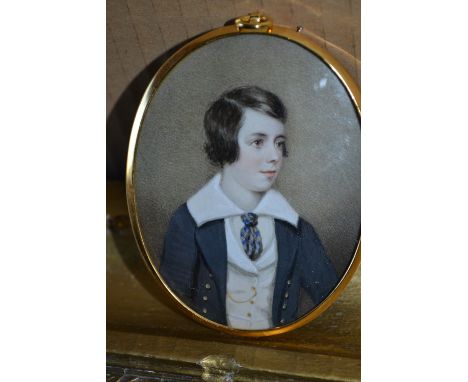 19th Century oval watercolour miniature head and shoulder portrait of a boy mounted in oval gilt metal frame