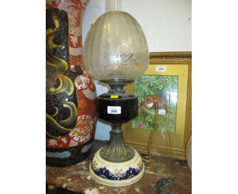 Porcelain brass and glass oil lamp base with etched shade and chimney, together with another etched glass shade and chimney
