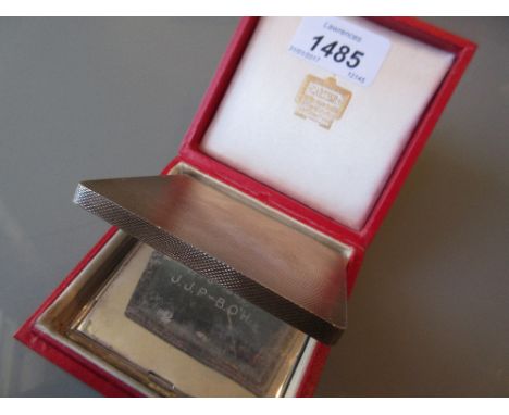Square silver compact with engine turned decoration housed in a Cartier box