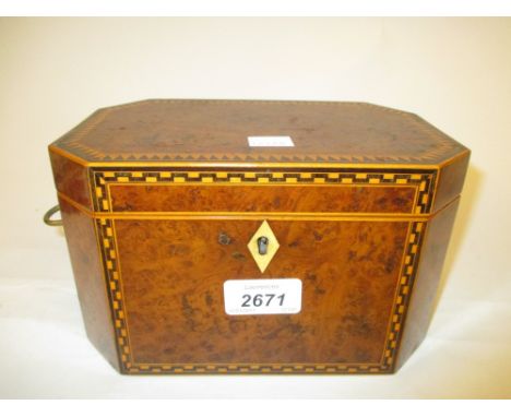 Regency burr yew and inlaid tea caddy of irregular octagonal form, the hinged lid enclosing a single section interior with br