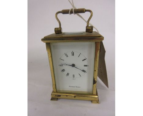 Small modern brass cased carriage clock with enamel dial and Roman numerals, signed Shortland Bowen with a single train movem