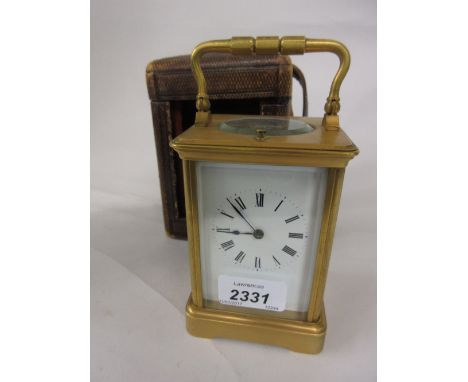 Late 19th or early 20th Century brass carriage clock, the matt gilt case enclosing an enamel dial with Roman numerals, with h