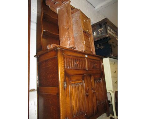 Reproduction oak dresser with a boarded shelf back above two drawers and two cupboard doors together with a similar small two