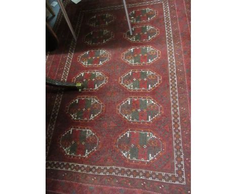 Afghan rug with two rows of six gols on a wine ground with borders