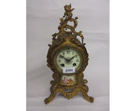 19th Century gilded spelter and porcelain mounted mantel clock of rococo design with a circular enamel dial, Arabic numerals 