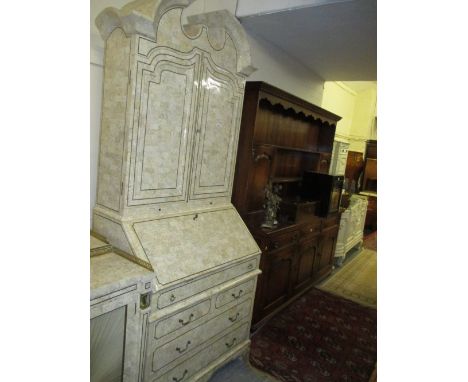 Unusual mid 20th Century pale variegated stone veneered bureau bookcase in 18th Century, the broken arch pediment above a pai