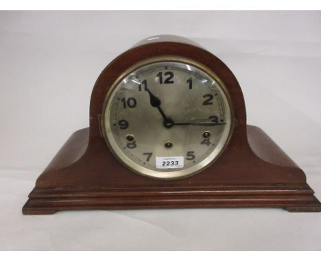 Early 20th Century mahogany dome shaped mantel clock with a circular silvered dial, Arabic numerals and three train movement