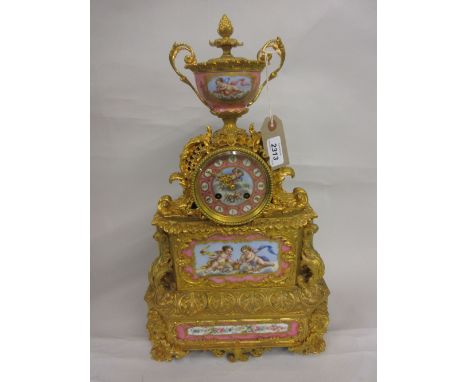 19th Century French ormolu and porcelain mounted mantel clock, the urn surmount above a rococo style case, the porcelain moun