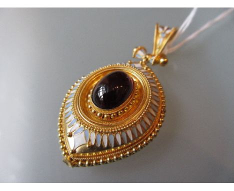 Victorian gold pendant locket set with a cabochon garnet and enamel decoration