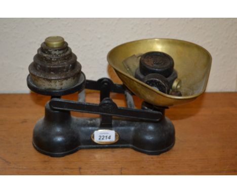Pair of black painted and brass kitchen scales with weights
