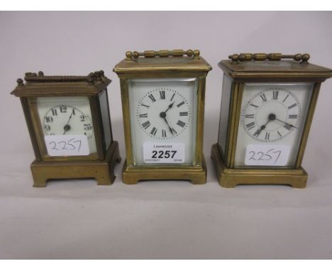 Two small brass cased single train carriage clocks, together with a small American brass cased carriage clock (a/f)