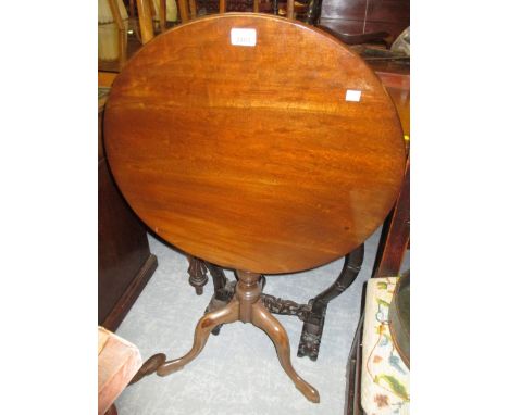 George III mahogany circular tilt top pedestal table with a turned column support and tripod base