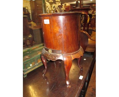 George III mahogany cylindrical wine cooler with a metal liner above a single drawer on cabriole supports with pad feet