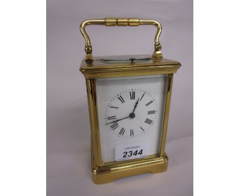 Late 19th or early 20th Century gilt brass cased carriage clock, the enamel dial with Roman numerals, the two train movement 