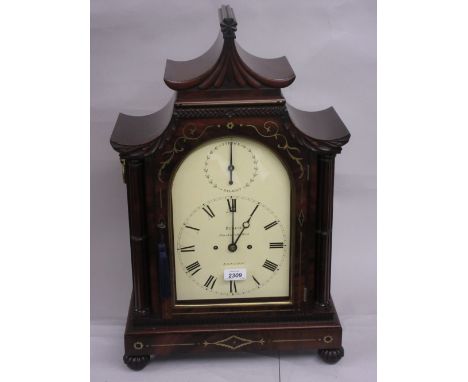 Late Regency mahogany and cut brass inlaid bracket clock, the pagoda case with a shaped top above an arched door flanked by c