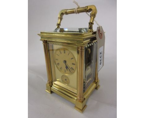 Small late 19th or early 20th Century brass cased carriage clock with plain turned corner pilasters, the gilt dial with Roman