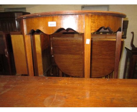 Mahogany and crossbanded half round side table and an oak aneroid barometer thermometer