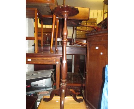 Mahogany candle stand with shaped top above a baluster column and tripod