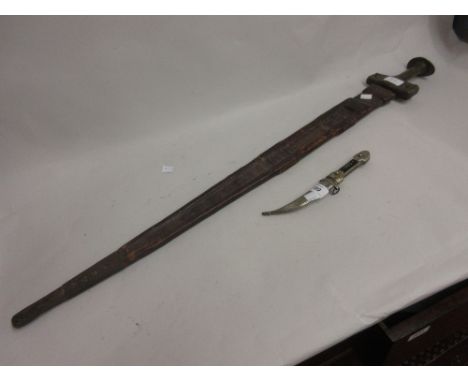 Small Eastern dagger together with an Eastern sword in a leather scabbard