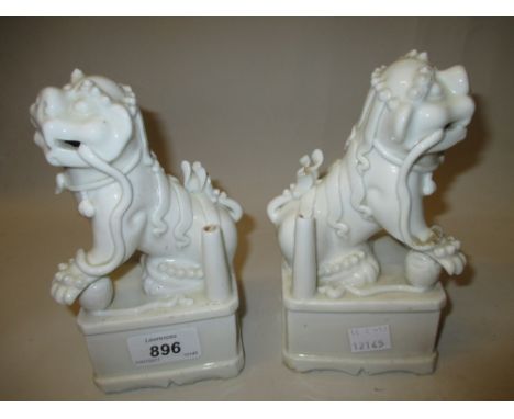 Pair of Chinese blanc de chine joss stick holders in the form of Kylin dogs, 6.75ins high