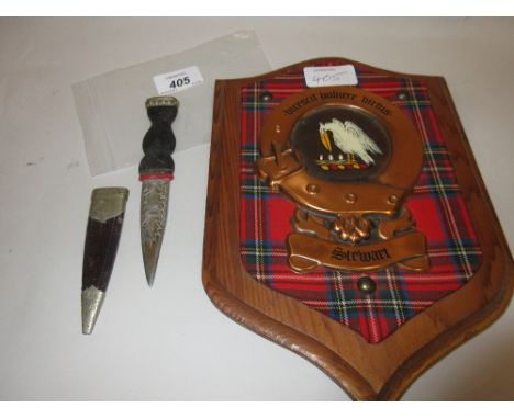 Scottish skeandu with carved wooden handle, leather scabbard and silver plated mount, together with a Stuart tartan plaque