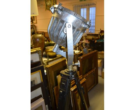 American polished steel search light by Phoenix Products of Milwaukee, with tripod stand together with a similar painted stee