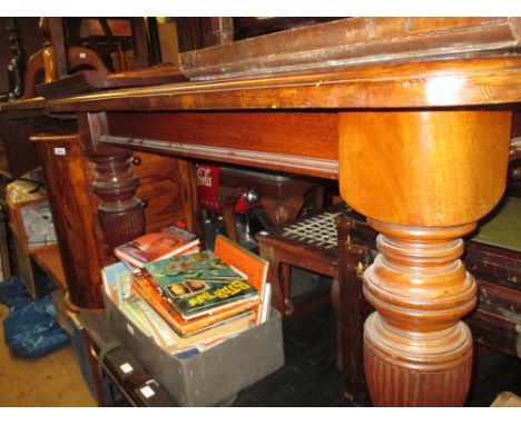 Late 19th Century mahogany rectangular wind-out extending dining table, the moulded top with two extra leaves, raised on balu