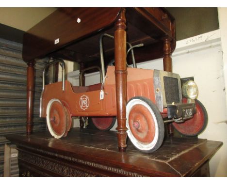 Red tin plate pedal car fire engine (a/f) together with a wooden scooter