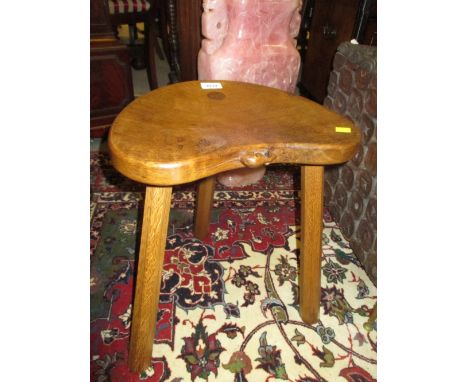 Robert Mouseman Thompson, oak stool with a shaped seat raised on three octagonal supports