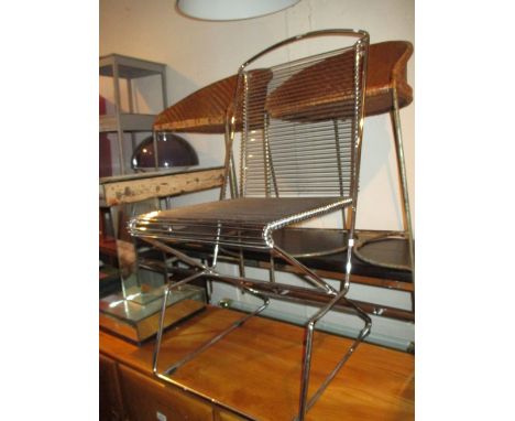 Modern chrome framed side chair with ladder back and seat