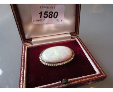 Large oval opal and diamond set brooch in a fitted box