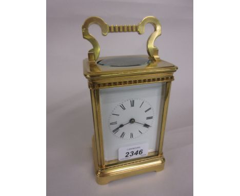 Late 19th or early 20th Century gilt brass cased carriage clock, the enamel dial with Roman numerals, the two train movement 