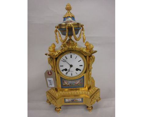 19th Century French gilt brass and porcelain mounted mantel clock, the ornate case with a vase and swag surmount, the porcela