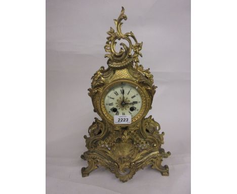 19th Century French ormolu mantel clock of Rococo design, the enamel dial with Arabic and Roman numerals, the two train movem
