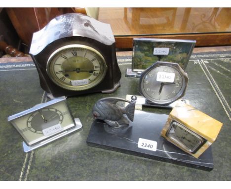 French black marble clock mounted with a patinated metal figure of a fish together with three various chrome plated mantel cl
