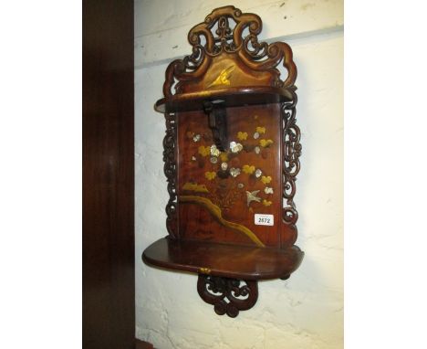 Late 19th Century Japanese hardwood two shelf wall bracket of shaped carved and pierced design decorated with a central panel