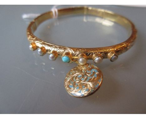 Victorian gold bangle set turquoise and pearls with a suspended enamel decorated locket